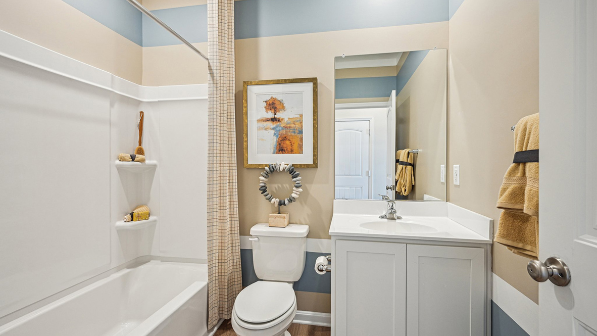 There is a full guest bathroom, located near the third bedroom at the rear of the home.