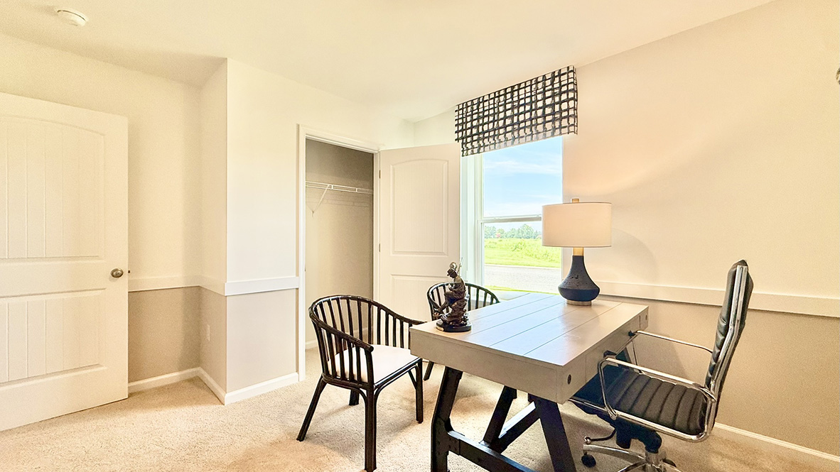 Just off the foyer, two spacious guest bedrooms and a shared full bathroom offer comfort and privacy for family or visitors.