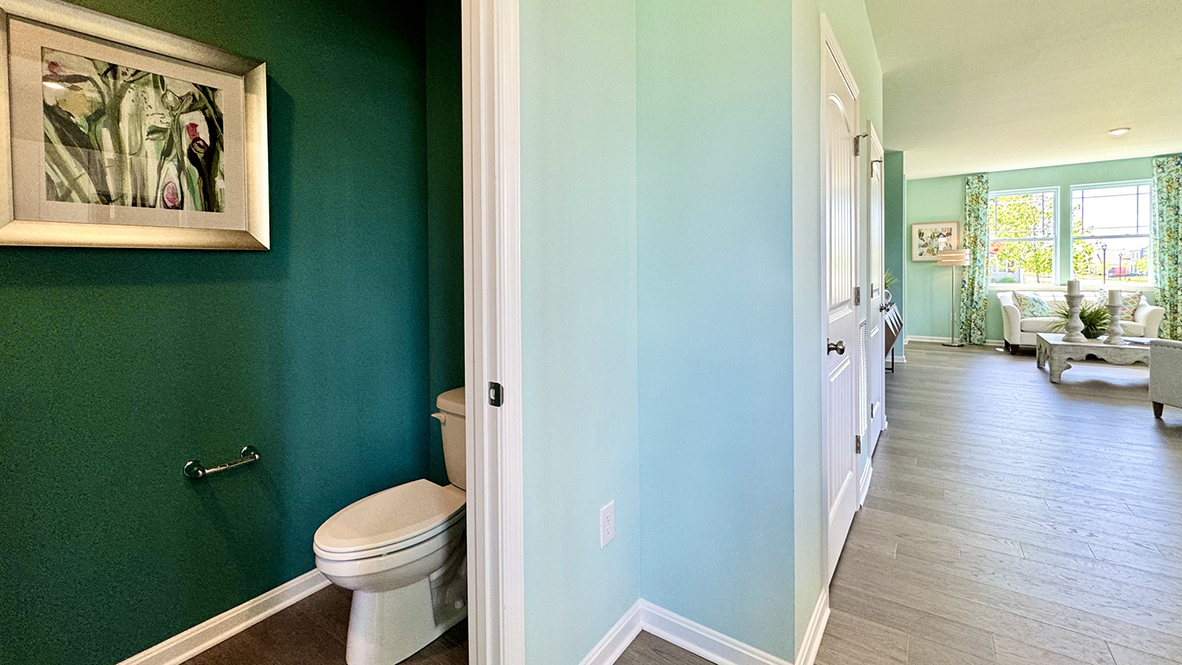 The powder room is tucked off the kitchen.