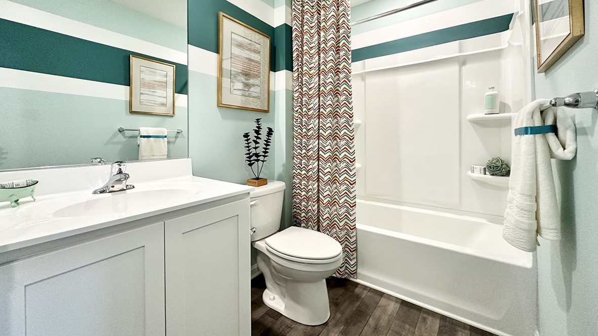 Secondary bathroom with shower, toilet and vanity.