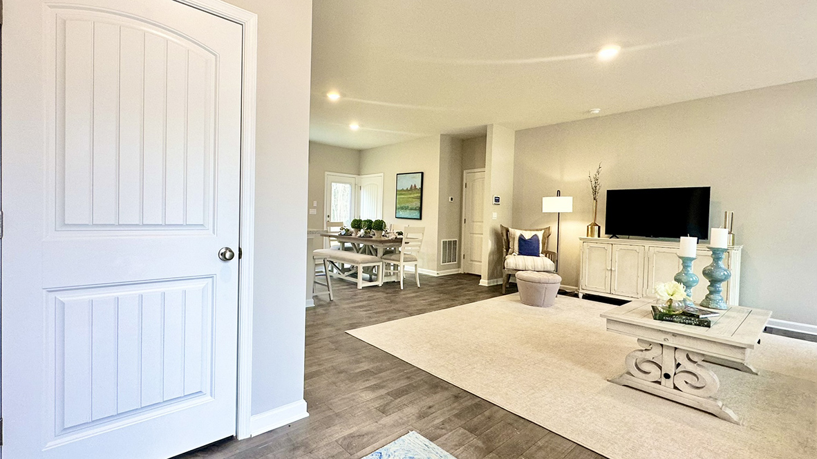 As you enter through the covered porch, the welcoming foyer opens into the dynamic open floor plan.