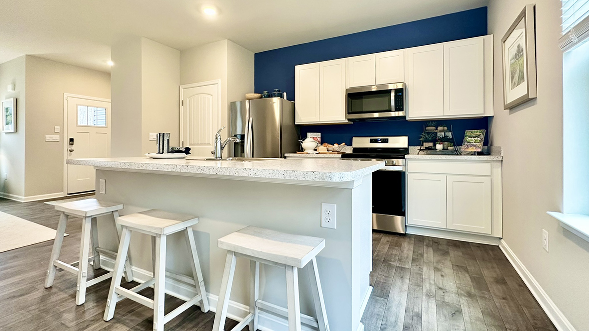 The home's well-designed eat-in kitchen boasts ample cabinet space.