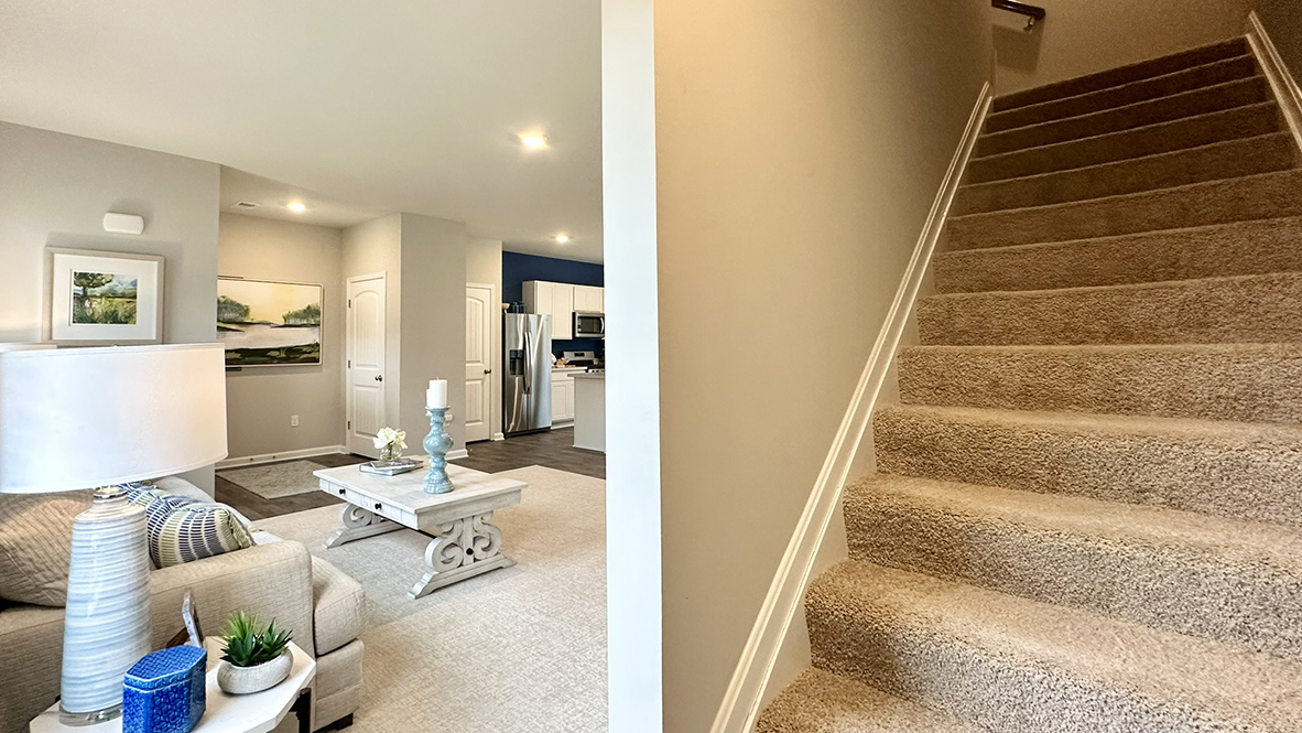 As you enter through the covered porch, the welcoming foyer opens into the dynamic open floor plan.