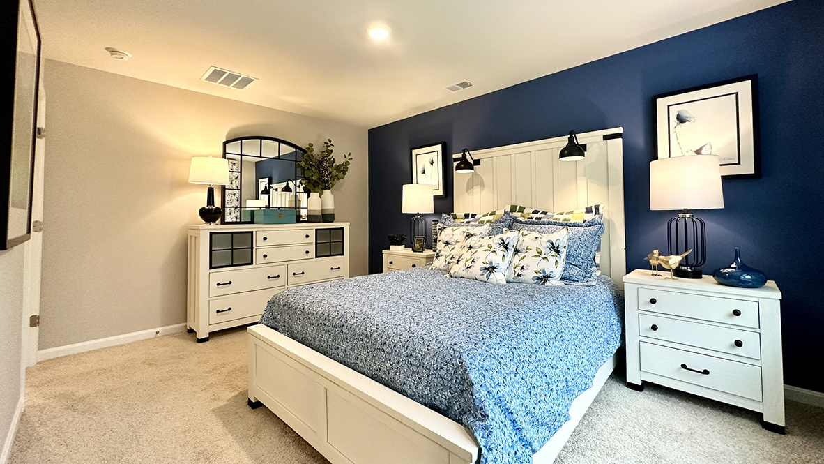 Upstairs, the first bedroom is complete with a full bathroom and walk-in closet.