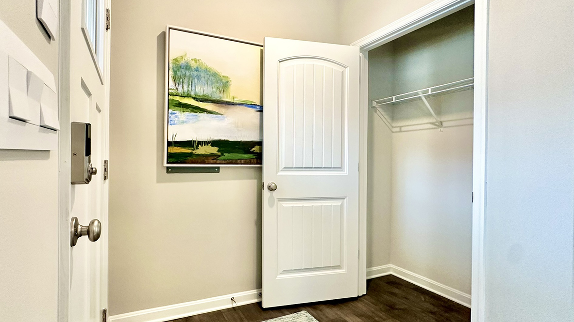 As you enter through the covered porch, the welcoming foyer features a convenient coat closet.