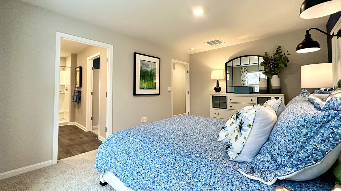 Upstairs, the first bedroom is complete with a full bathroom and walk-in closet.