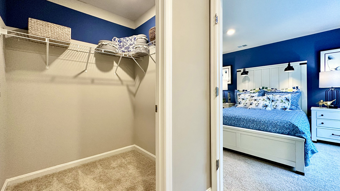 Upstairs, the first bedroom is complete with a full bathroom and walk-in closet.