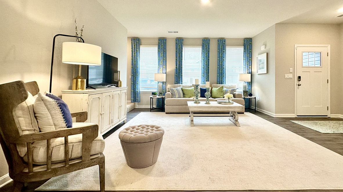 As you enter through the covered porch, the welcoming foyer opens into the dynamic open floor plan.