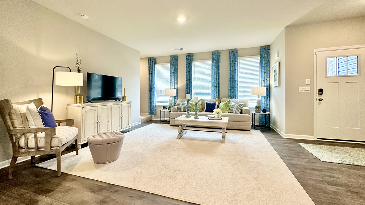 As you enter through the covered porch, the welcoming foyer opens into the dynamic open floor plan.