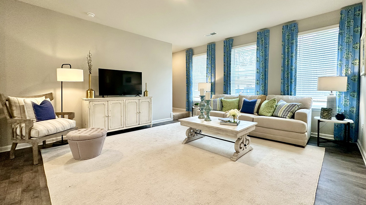 As you enter through the covered porch, the welcoming foyer opens into the dynamic open floor plan.