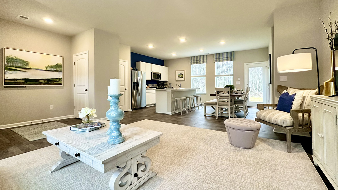 As you enter through the covered porch, the welcoming foyer opens into the dynamic open floor plan.