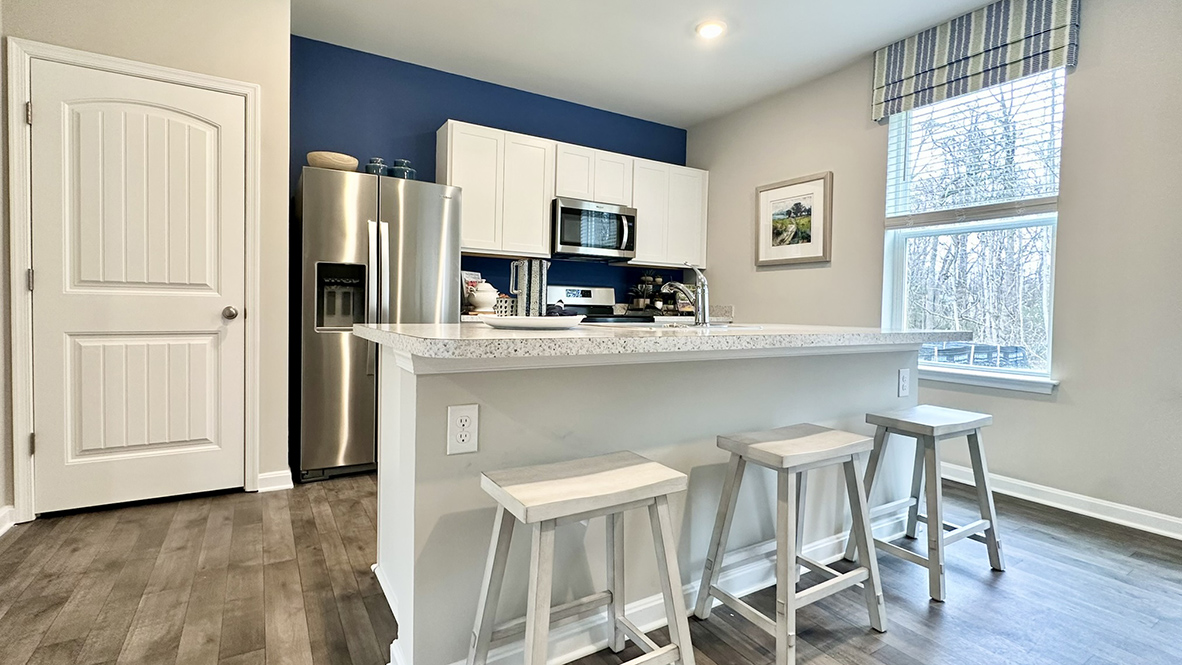 The home's well-designed eat-in kitchen boasts a large island.