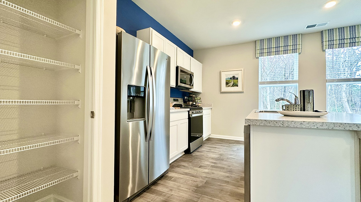 The home's well-designed eat-in kitchen boasts stainless steel appliances.