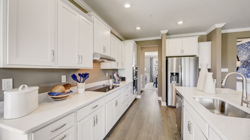 A gourmet kitchen is adorned with ample quartz counter space.