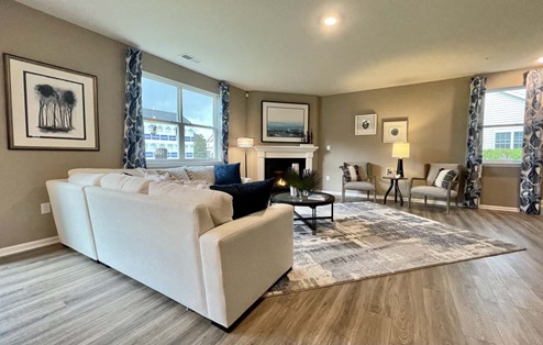 Hanover open-concept first floor living room with a fireplace.