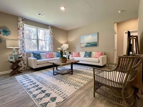 Large living room with large windows.
