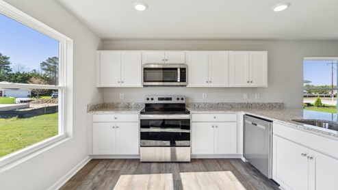 The well-equipped kitchen is complete with modern cabinetry.