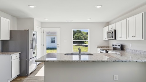 The well-equipped kitchen is complete with a spacious peninsula island with room for seating.