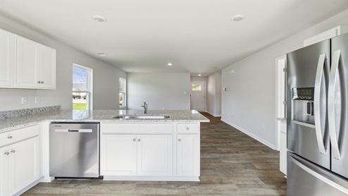 The well-equipped kitchen is complete stainless steel appliances.