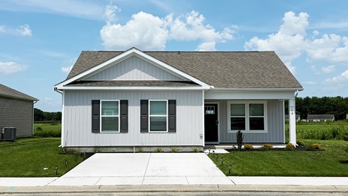 A Curtis one-story home with gray siding.