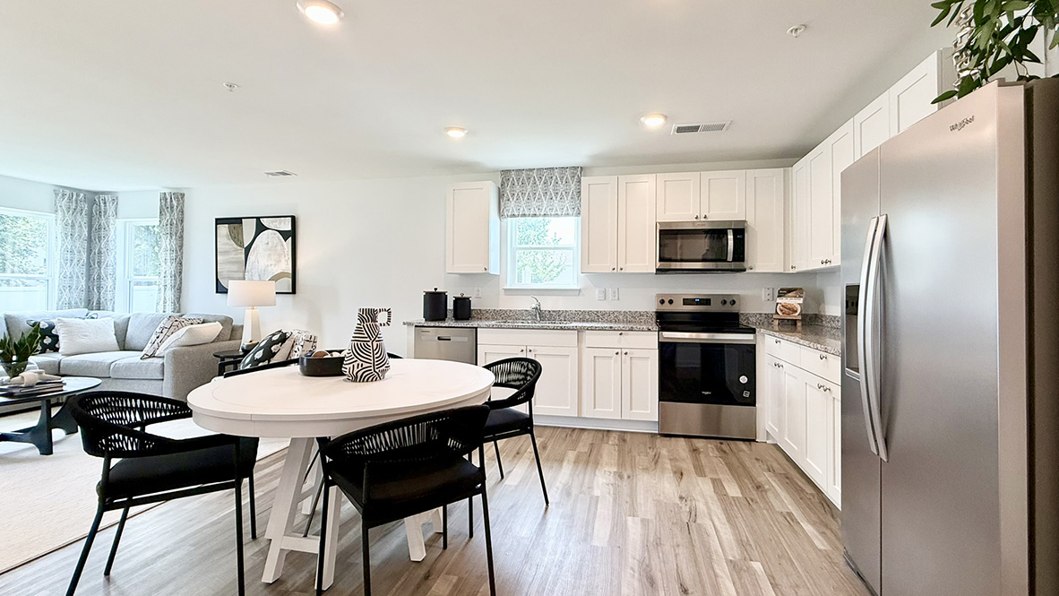 The open-concept kitchen boasts stainless steel appliances.