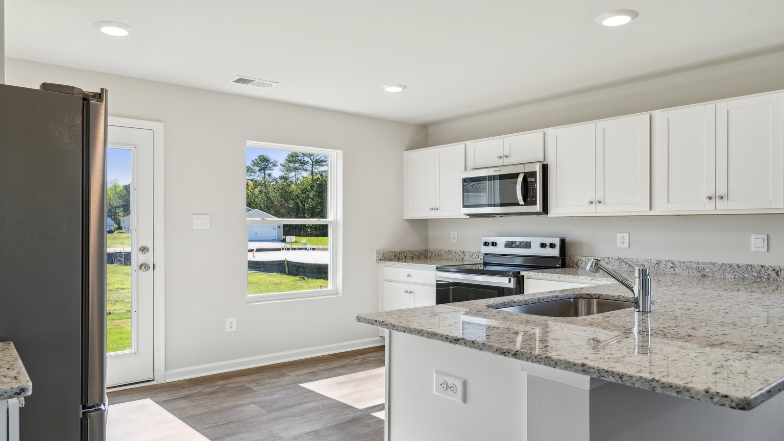The well-equipped kitchen is complete granite countertops.
