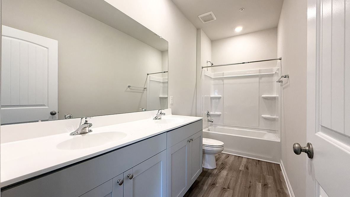 The main bedroom is set apart in the back of the home and features a walk-in closet and full bathroom.