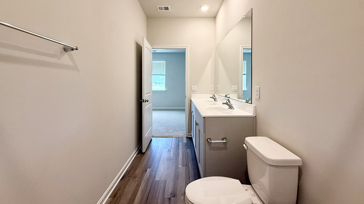 The main bedroom is set apart in the back of the home and features a walk-in closet and full bathroom.