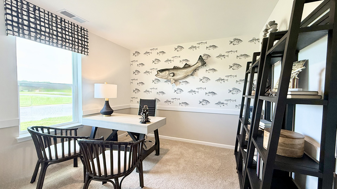 Just off the foyer, two spacious guest bedrooms and a shared full bathroom offer comfort and privacy for family or visitors.