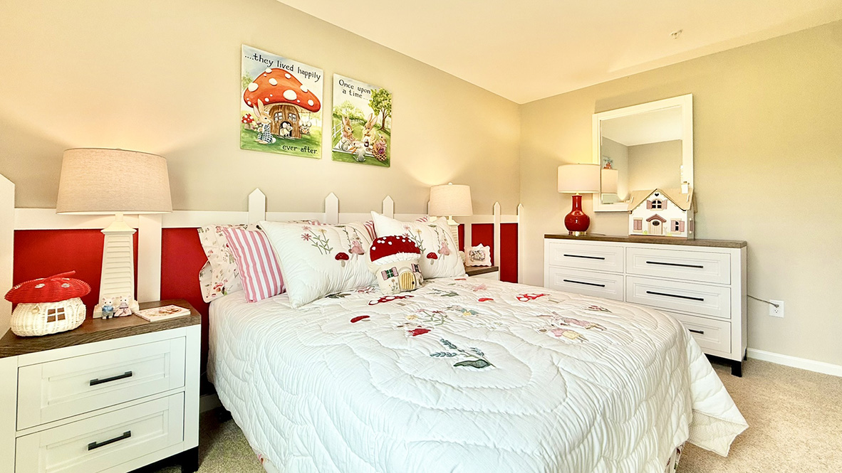 Just off the foyer, two spacious guest bedrooms and a shared full bathroom offer comfort and privacy for family or visitors.