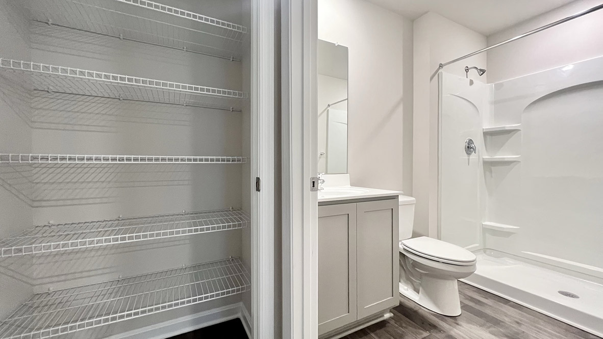 Adjacent to the downstairs full bathroom is a linen closet.