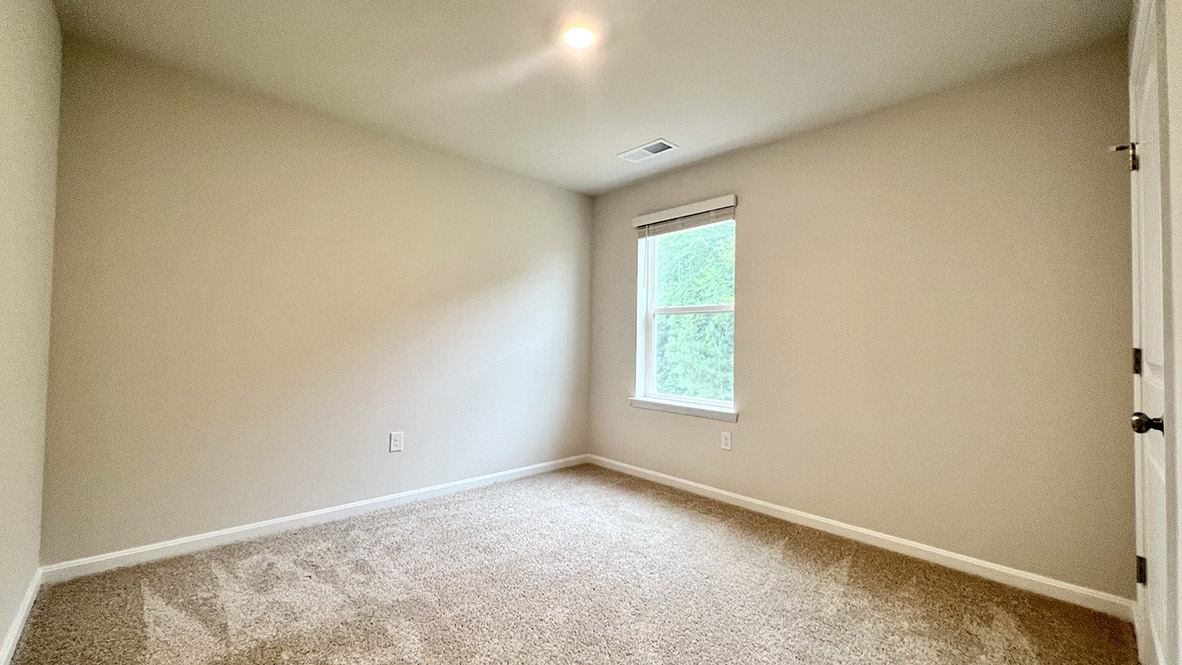 A secondary bedroom with a window.