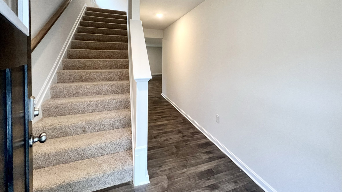 As you enter the home from the covered porch and step into the home's distinct foyer.
