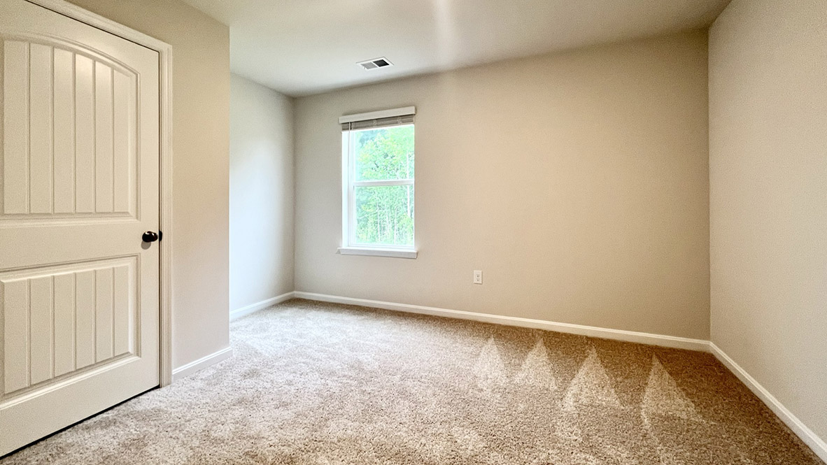 A first-floor, secondary bedroom that can be used for overnight guests, a home office, or a hobby room.