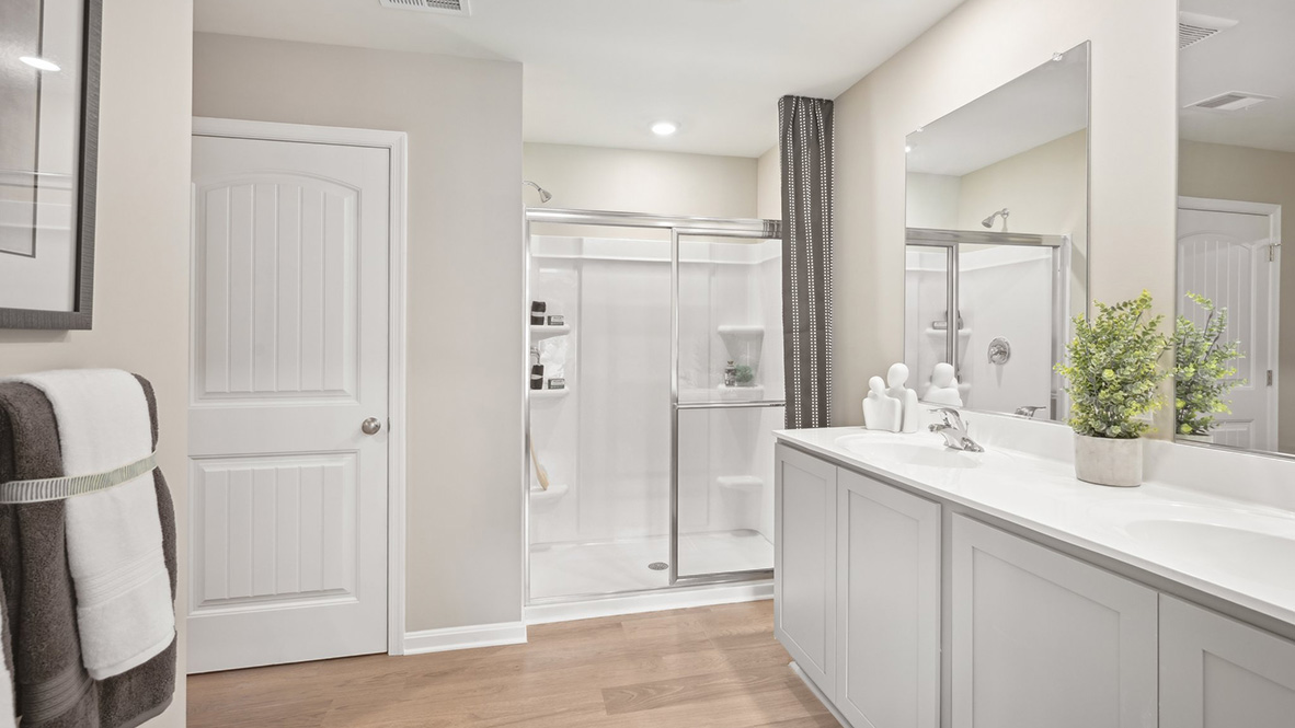 The primary bathroom has a double-bowl vanity.