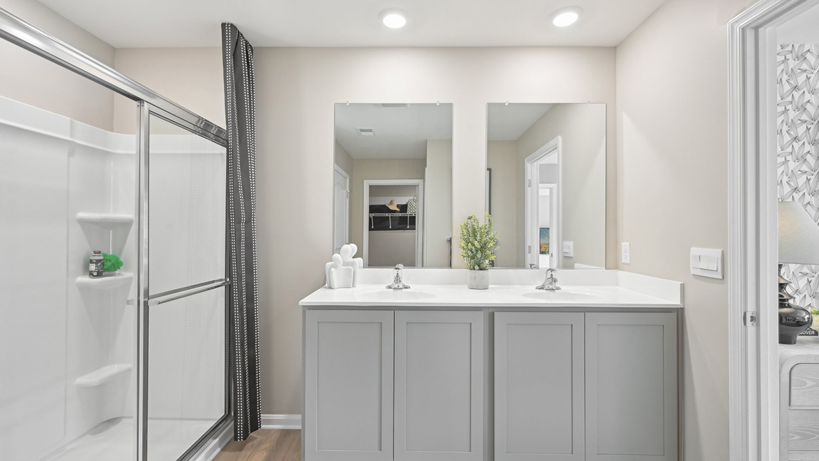 The primary bathroom has a double-bowl vanity.