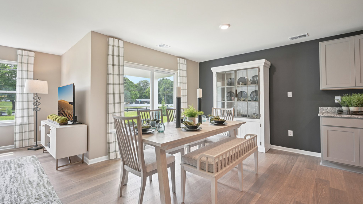 The kitchen is open to the informal dining area that leads to the back sliding door.