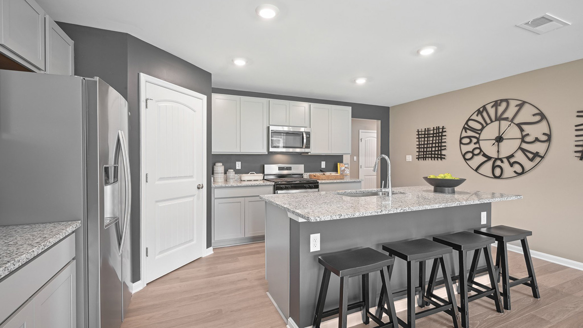 The kitchen includes stainless steel appliances.