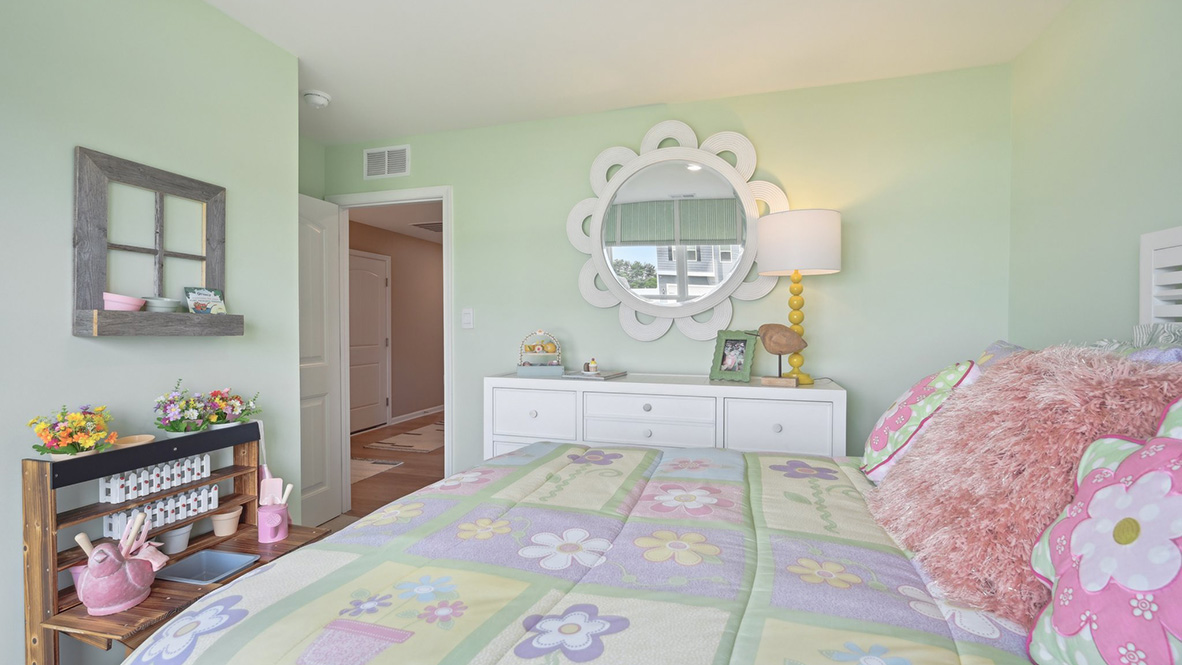 The guest bedroom has a corner closet.