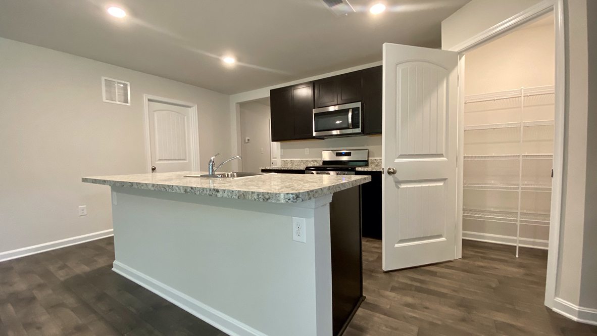 The home's well-designed kitchen offers a generous corner pantry.