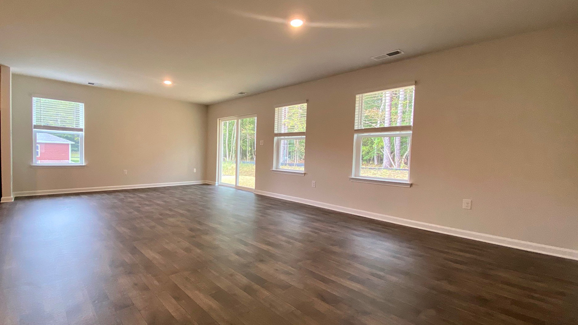 The ample great room and dining area both offer an abundance of natural light.