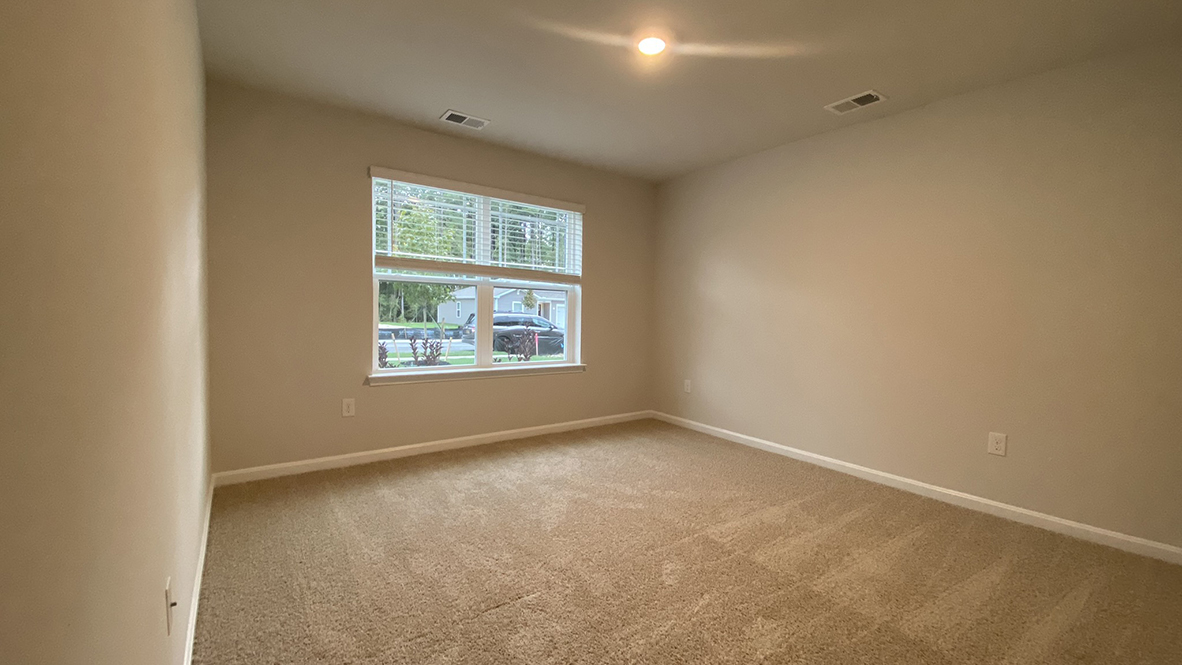 A spacious guest bedroom with a closet is in the front of the home.