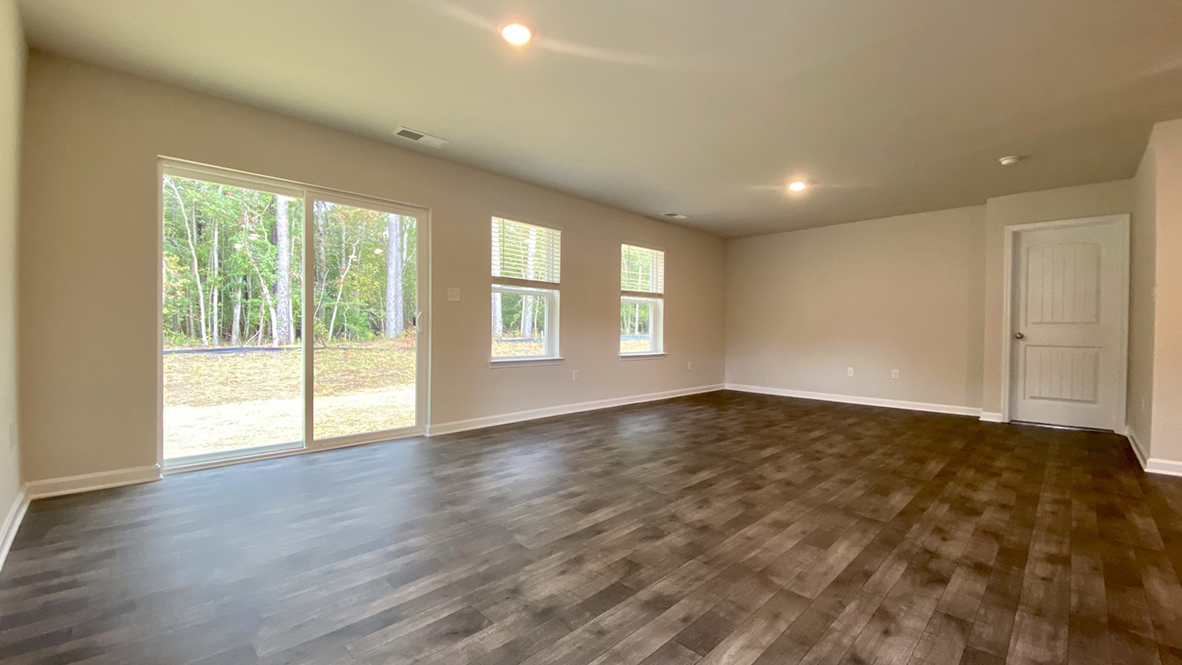 The living area has a sliding glass door to the backyard.