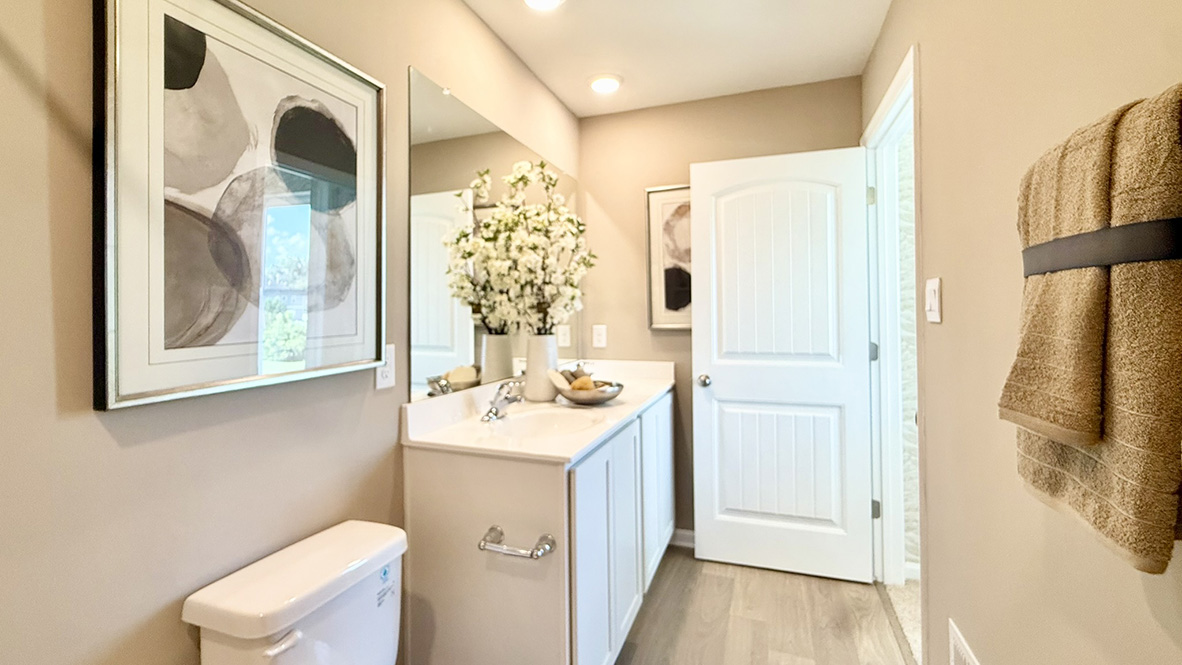 The modern main bathroom has a double bowl vanity.