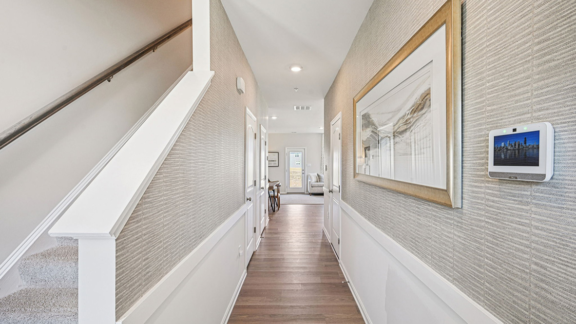 As you enter from the front porch, the inviting foyer leads you to a long hallway.