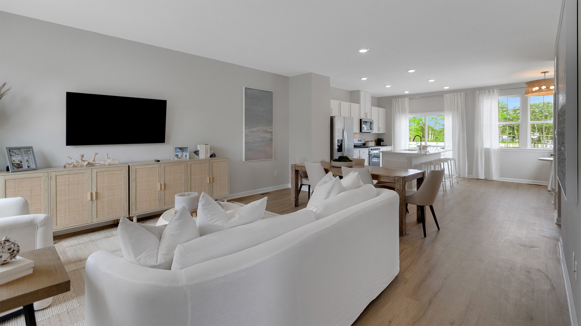 The kitchen flows seamlessly into the bright dining and living areas.