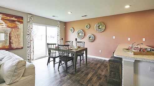 The oversized great room with an abundance of natural light is open to the dining area.