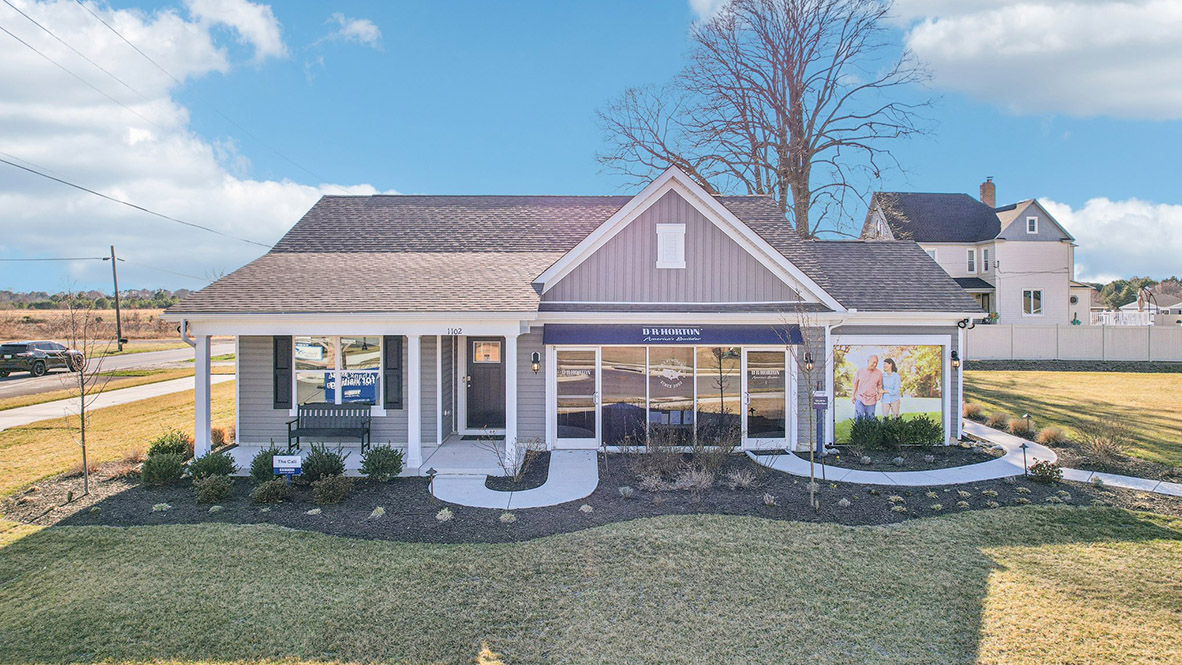 The Birdsong Village model home with blue siding and a three-car garage.