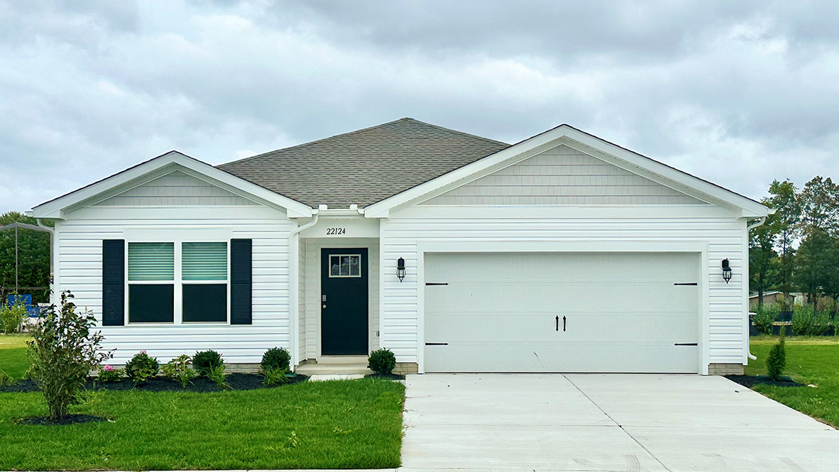 A one-story Cali home with white siding and black shutters.