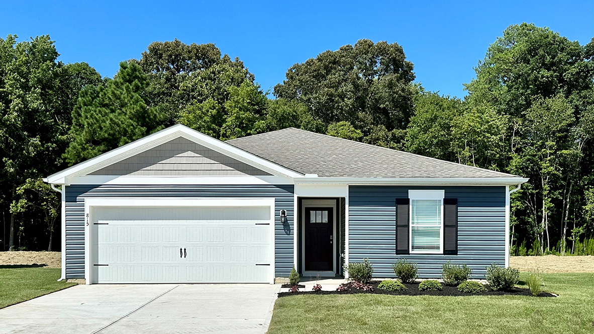 A Neuville ranch home with blue siding and black shutters.